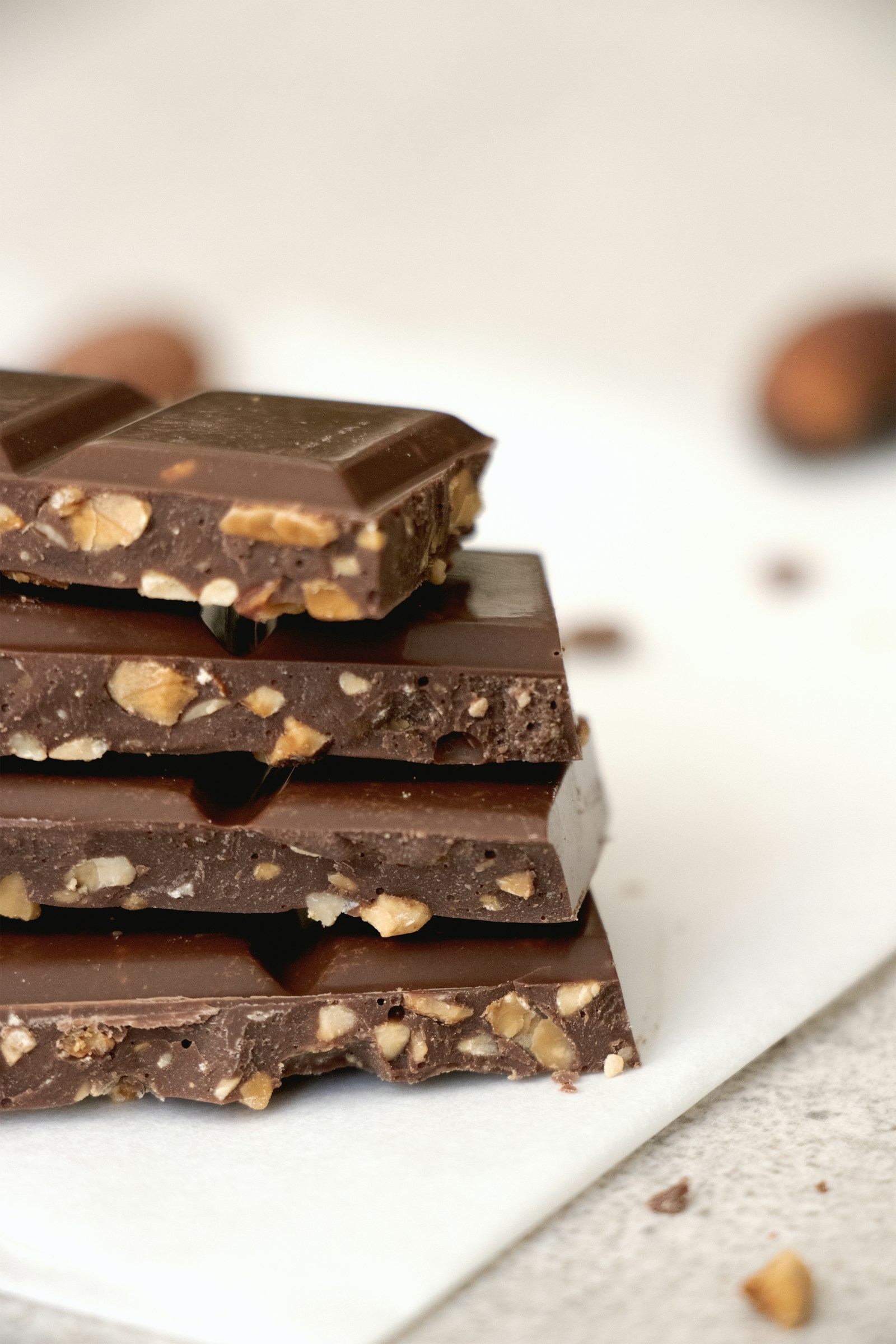 A stack of chocolate with whole hazelnuts